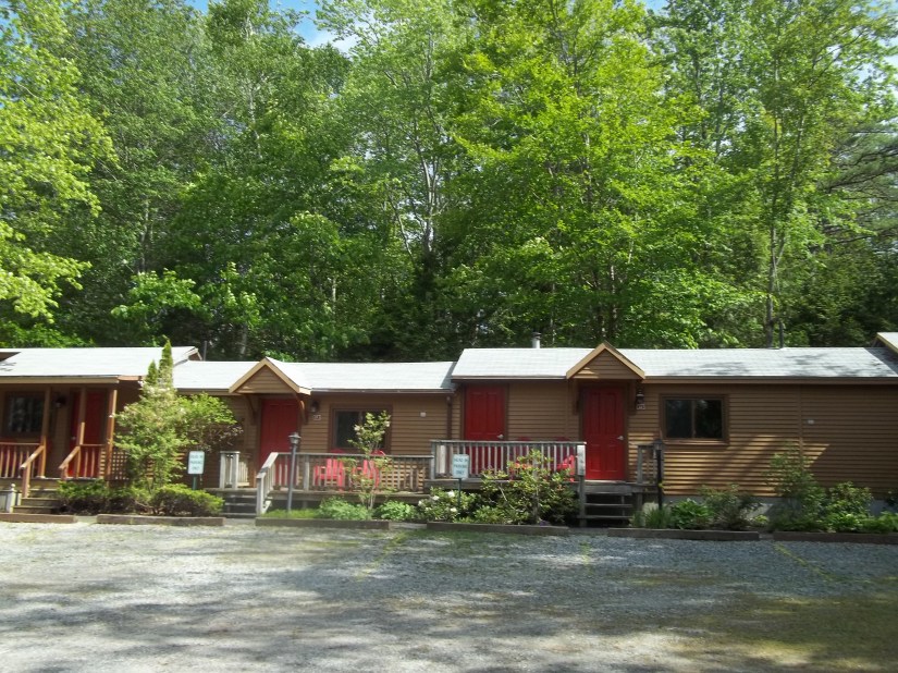Cottage rooms with private front porches at Wiscasset Woods Lodge in Midcoast Maine.