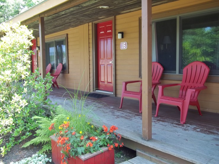 Photo of the cottage rooms with vertical slats covering the 2 feet of space between each cottage room.