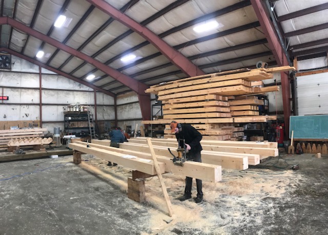 Working on the beams for a custom designed building built at the Shelter Institute
