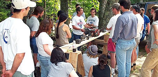Students gather around to learn the use of woodworking tools at the Shelter Institute in Maine