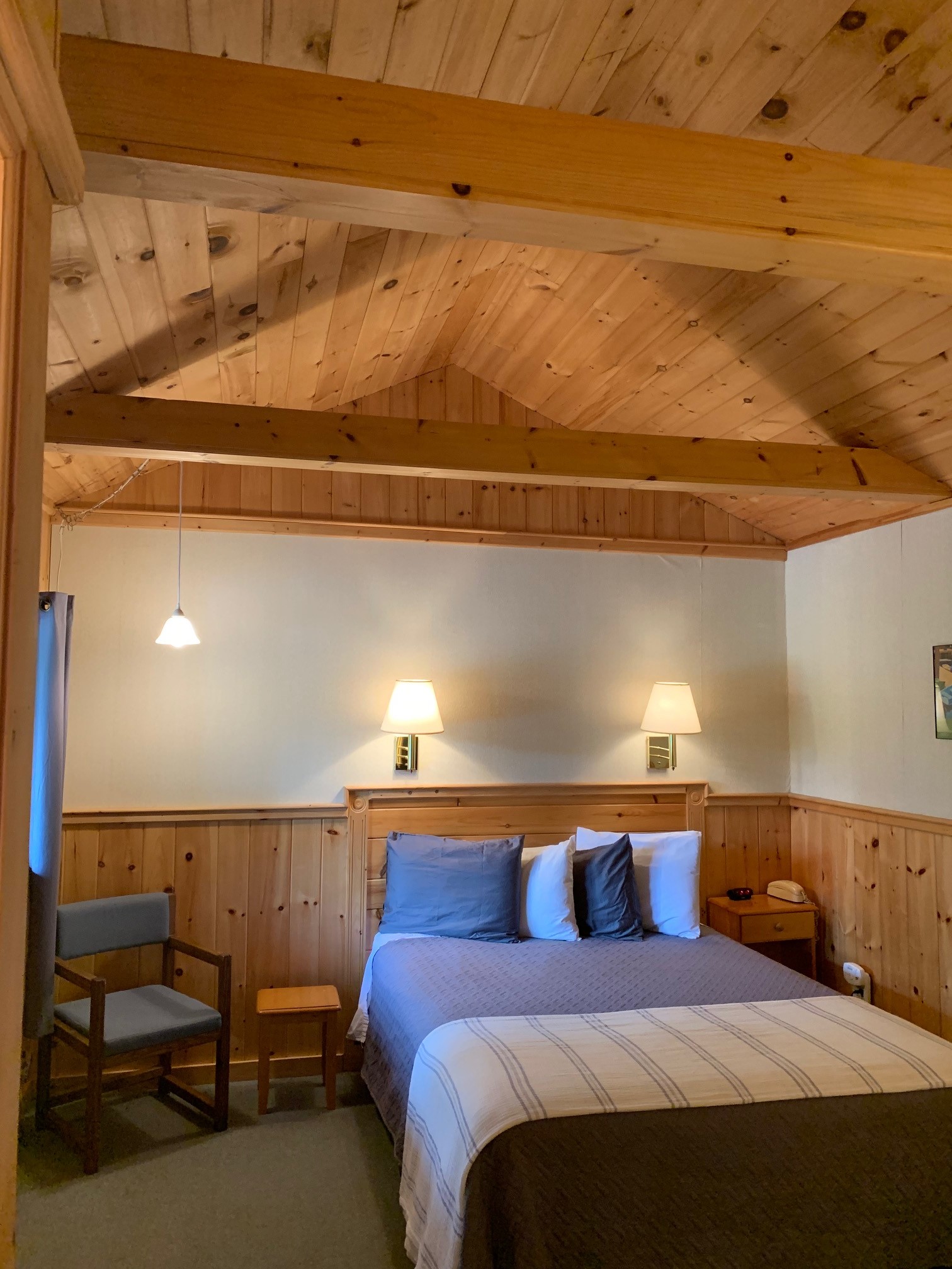 Photo of one of our cottage rooms with their knotty pine interior and vaulted ceiling.